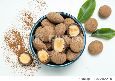Tasty and sweet food - almonds in chocolate 107202210
