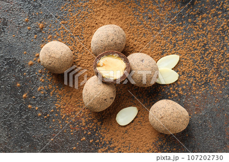 Tasty and sweet food - almonds in chocolate 107202730