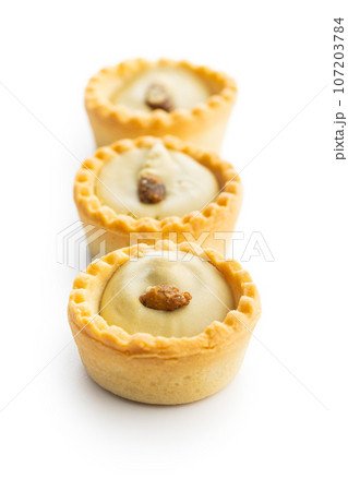 Sweet tarlets. Tasty mini tarts. Mini pie with cream isolated on white background. 107203784