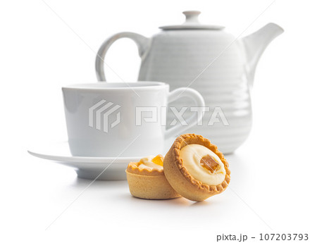 Sweet tarlets. Tasty mini tarts and coffee cup. Mini pie with cream isolated on white background. 107203793