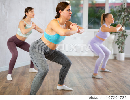 Young woman doing fitness in fitness studio Young woman doing fitness in fitness studio 107204722
