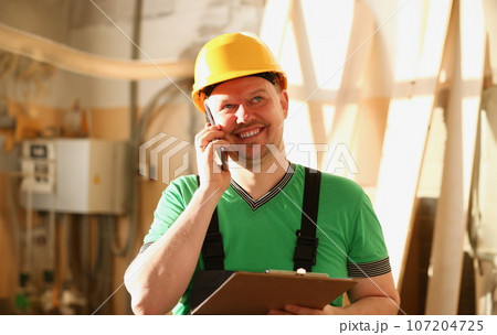 Carpenter talking on phone in hardware store 107204725