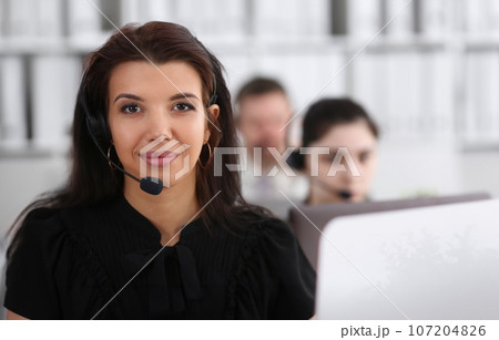 Three call centre service operators at work 107204826