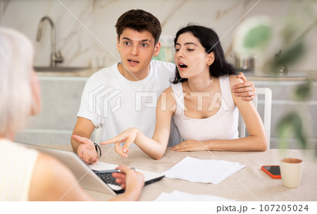 Insurance agent explaining conditions of insurance in home Insurance agent explaining conditions of insurance in home 107205024