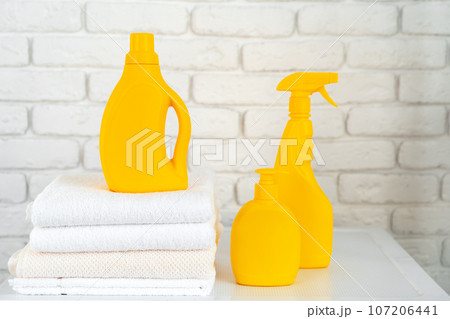 Detergent bottle on washing machine in a laundry room 107206441