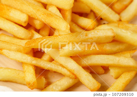 Fresh tasty fried French fries close up. Selective focus 107209310