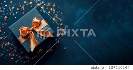 Banner with dark blue gift box with ribbon and bow for man and boy isolated on blue background.Holiday gift with Birthday or Christmas present,flat lay,top view,father's day,copy space.Generated by AI 107210144