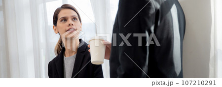 Young manager talking with secretary about report marketing on digital tablet for planning. Young manager talking with secretary about report marketing on digital tablet for planning. 107210291