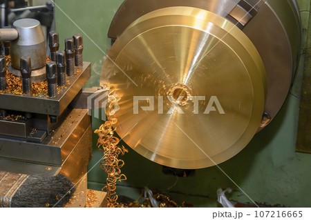 Closeup scene the lathe machine finish cut the brass parts by lathe tools. Closeup scene the lathe machine finish cut the brass parts by lathe tools. 107216665