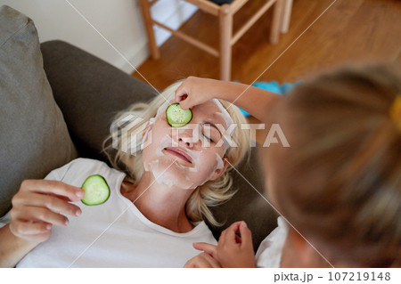 Daughter helps mom with beauty treatments 107219148