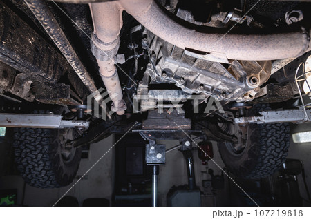 View of the off-road car from below on the lift. Auto service center. Vehicle maintenance 107219818