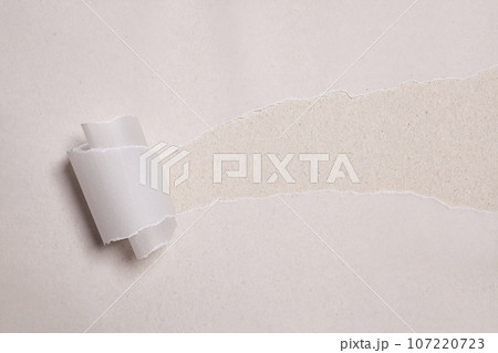 Torn paper with opening showing white background. Torn paper with opening showing white background. 107220723