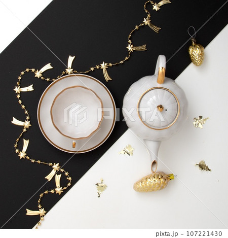 New Year's photo. Kettle and cup on the festive New Year's photo. Kettle and cup on the festive 107221430