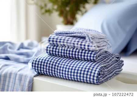 a clean pair of pajamas folded on a bed 107222472