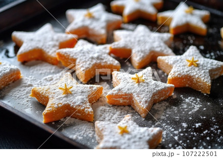 close-up of sugar-dusted, star-shaped cookies on a baking tray close-up of sugar-dusted, star-shaped cookies on a baking tray 107222501