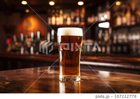 a pint of ale isolated against a bar backdrop 107222778