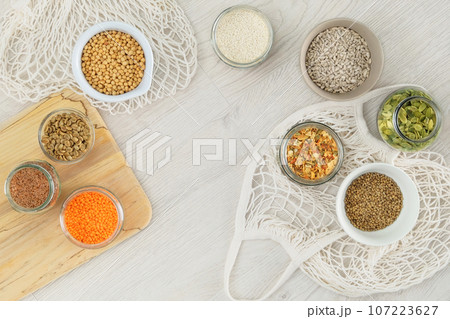 Grocery in bowls. Protein pulse and groats that is dried and then soaked and cooked before eating. Vegetarian organic product. Top view. Grocery in bowls. Protein pulse and groats that is dried and then soaked and cooked before eating. Vegetarian organic product. Top view. 107223627