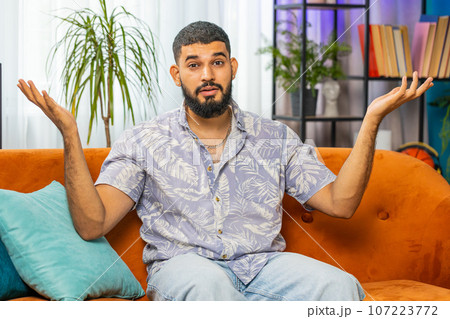 Indian young man asking why, what reason of failure, demonstrating disbelief irritation by troubles Indian young man asking why, what reason of failure, demonstrating disbelief irritation by troubles 107223772