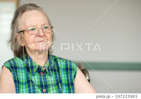 Portrait of a dreaming 84 yo white grandmother, Belgium 107223981