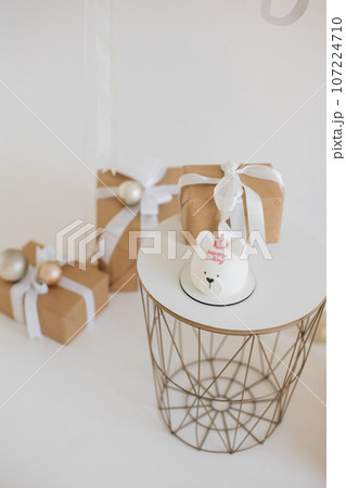 Modern table with white delicious cake in form of bear on it Modern table with white delicious cake in form of bear on it 107224710