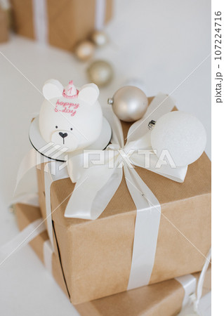 Birthday photo area with cake placed atop one of presents 107224716