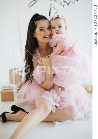 Mother and little daughter celebrating birthday in studio Mother and little daughter celebrating birthday in studio 107224753