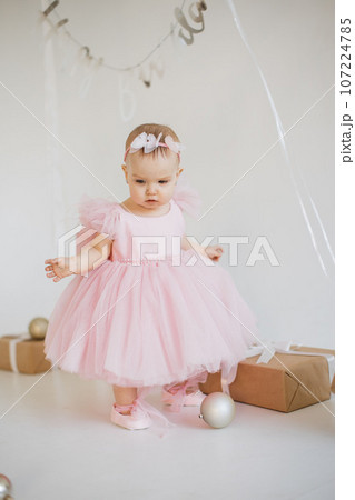 Little girl standing in studio with decorations for birthday 107224785