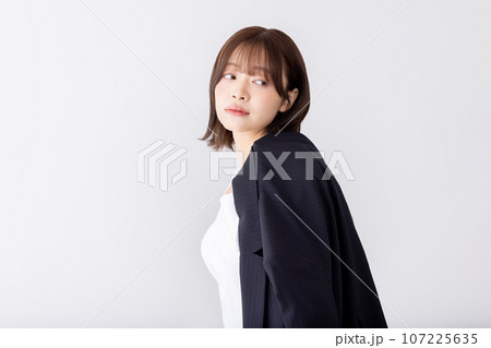 スーツを肩にかけるビジネスウーマン　背負う　担ぐ 107225635