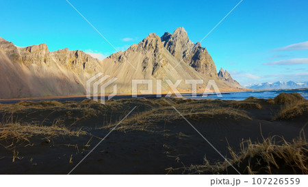 Beautiful vestrahorn mountains and hills in iceland with black sand beach and spectacular scandinavian landscapes. Stokksnes beach with panoramic view of icelandic nature. Handheld shot. 107226559
