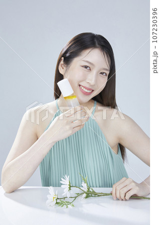 beauty concept photo of korean asain beautiful woman with cosmetic and a recycle bottle 107230396