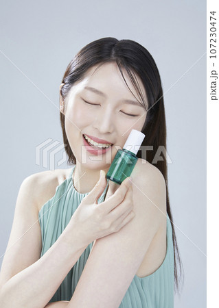 beauty concept photo of korean asain beautiful woman with cosmetic and a recycle bottle 107230474