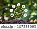 Tree growing on the ground and icons related to green energy, Earth Day concept, and energy saving. 107233093