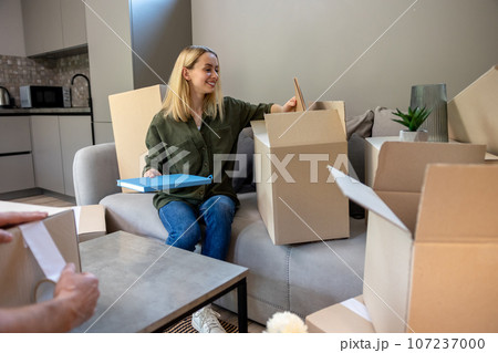 Two people looking busy while packing the boxes for relocation 107237000