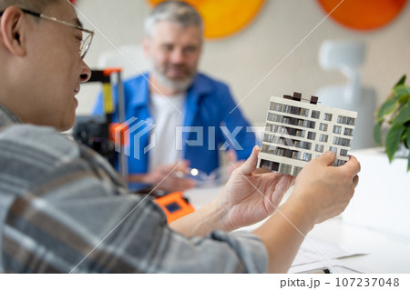 Architects making house model working with 3D printer, creating process. Architects making house model working with 3D printer, creating process. 107237048