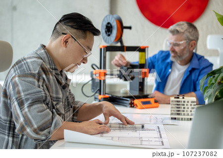 Architects making house model using 3D printer, FDM technology for architectural use. Architects making house model using 3D printer, FDM technology for architectural use. 107237082
