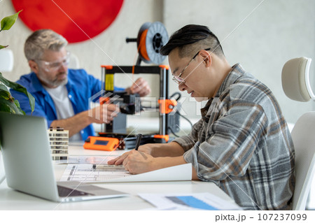 Architects making house model using 3D printer, FDM technology for architectural use. Architects making house model using 3D printer, FDM technology for architectural use. 107237099