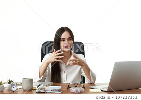 beautiful businesswoman talking on video call to client beautiful businesswoman talking on video call to client 107237353