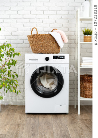 Laundry basket on washing machine in a laundry room Laundry basket on washing machine in a laundry room 107238319