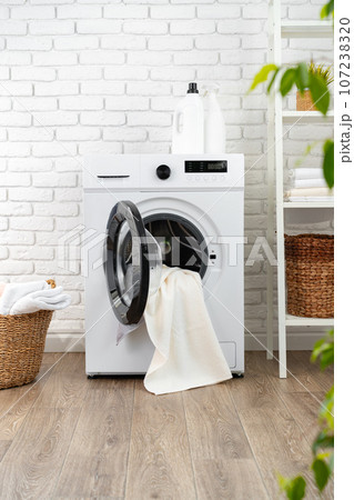 Washing machine and basket in a laundry room Washing machine and basket in a laundry room 107238320