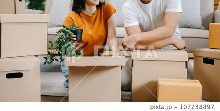 Happy asian young attractive couple man and woman with big boxes moving into a new house, new apartment for couple the new home, Moving house. Happy asian young attractive couple man and woman with big boxes moving into a new house, new apartment for couple the new home, Moving house. 107238897
