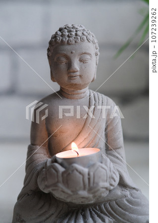 a small stone statue of Buddha 107239262
