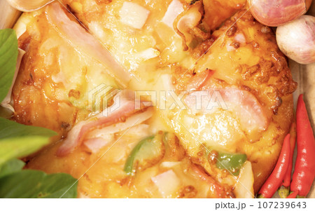 Pizza background in fast food close up with fresh paprika, garlic, shallots Pizza background in fast food close up with fresh paprika, garlic, shallots 107239643