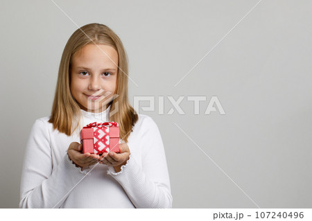 Cute pretty kid girl with gift on white background Cute pretty kid girl with gift on white background 107240496