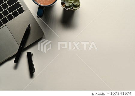 Flat lay, top view of laptop computer, coffee cup and succulent plant on white office desk 107241974