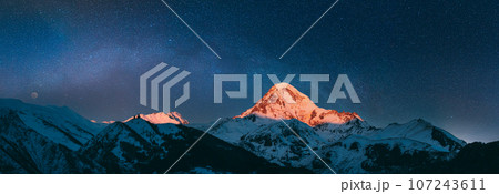 Georgia. Mount Kazbek Covered Snow In Winter Sunrise. Morning Dawn Colored Top Of Mountain In Pink-orange Colors. Awesome Winter Georgian Nature Landscape. 107243611
