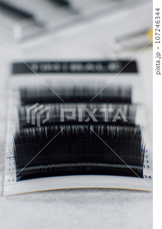 Group of different length, shape, thickness of eyelashes for extension on white background. Concept of beauty. 107246344