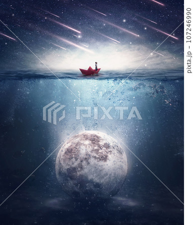Boy sailing in a paper boat searching for the moon sunken underwater. Satellite drowned in the ocean water in a mysterious night with falling stars. Surreal background, mystical adventure concept 107246990