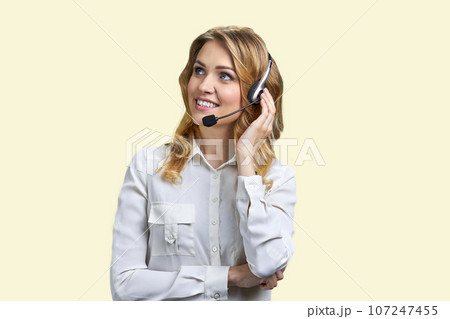 Portrait of smiling blond business woman with headset. Customer support and helpdesk. 107247455
