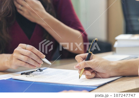 close up Team Businesswoman partners sign contract with success business joint venture deal. Diversity Businesswoman teams handshake together. Partnership teamwork meeting signing contract business 107247747