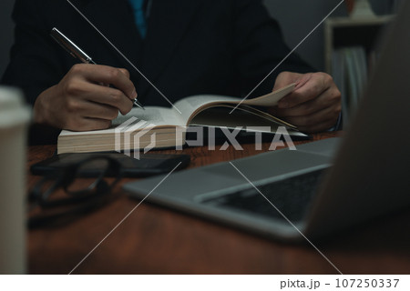 hand man writing notes workspace using a computer. communication and information management. education, business, or creative business concept. 107250337